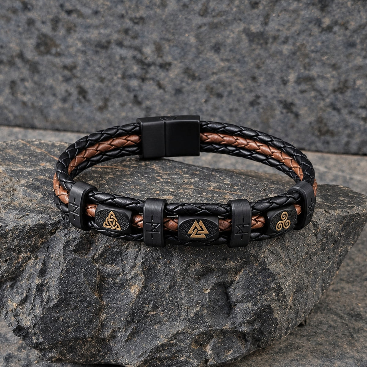 Valhalla · Banded Leather in Ironbark: black leather outer braids · saddle-brown centre braid · black beads · gold trinity knot, valknut + triskele · black bands · black slide-lock clasp