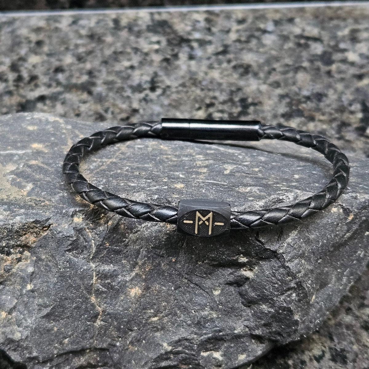 Signature · Black in Black: black 4 mm leather · black bead · bronze Totemband mark · black clasp