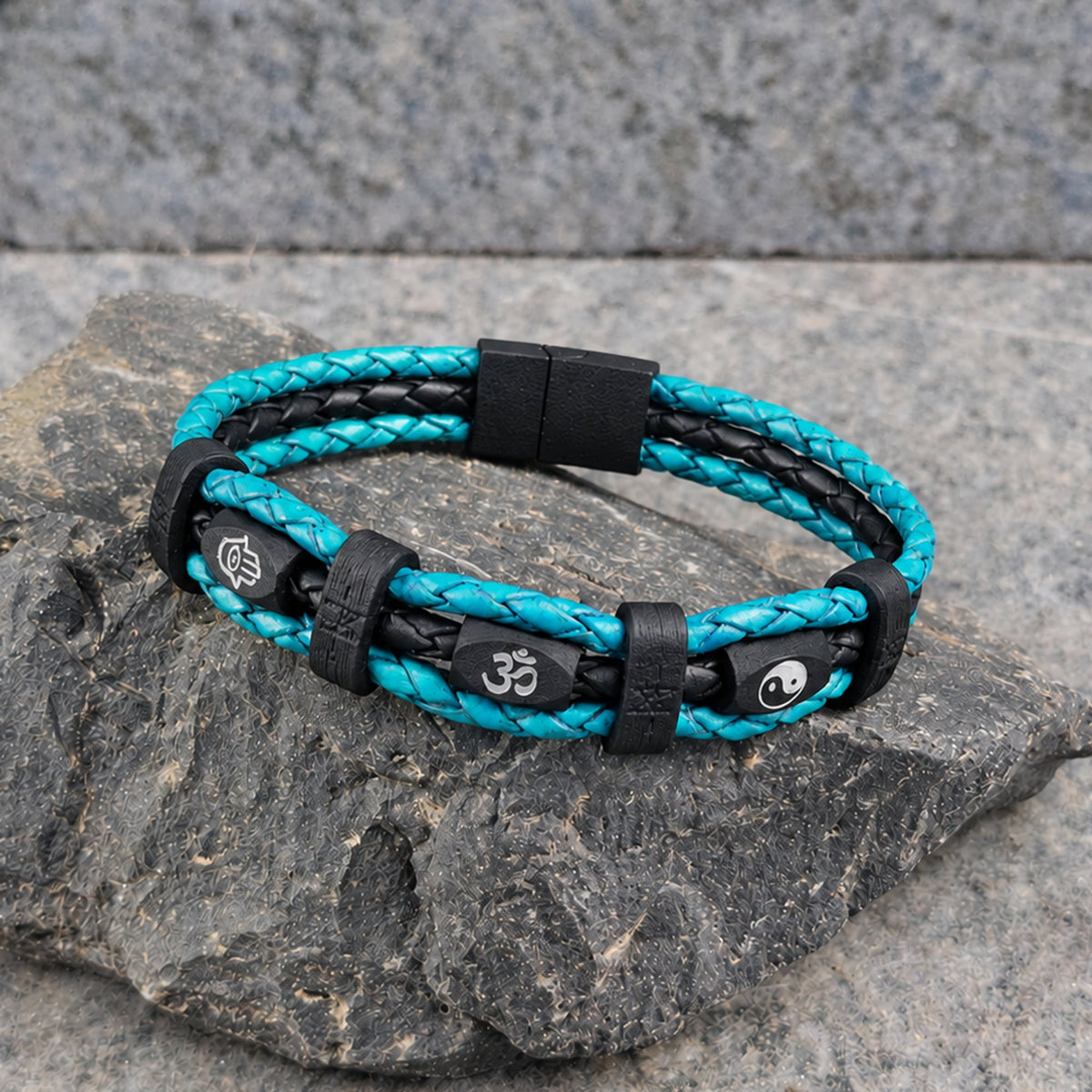 Mantra · Banded Leather in Turquoise: turquoise leather outer braids · black centre braid · black beads · white hamsa, om + yin yang · black bands · black slide-lock clasp